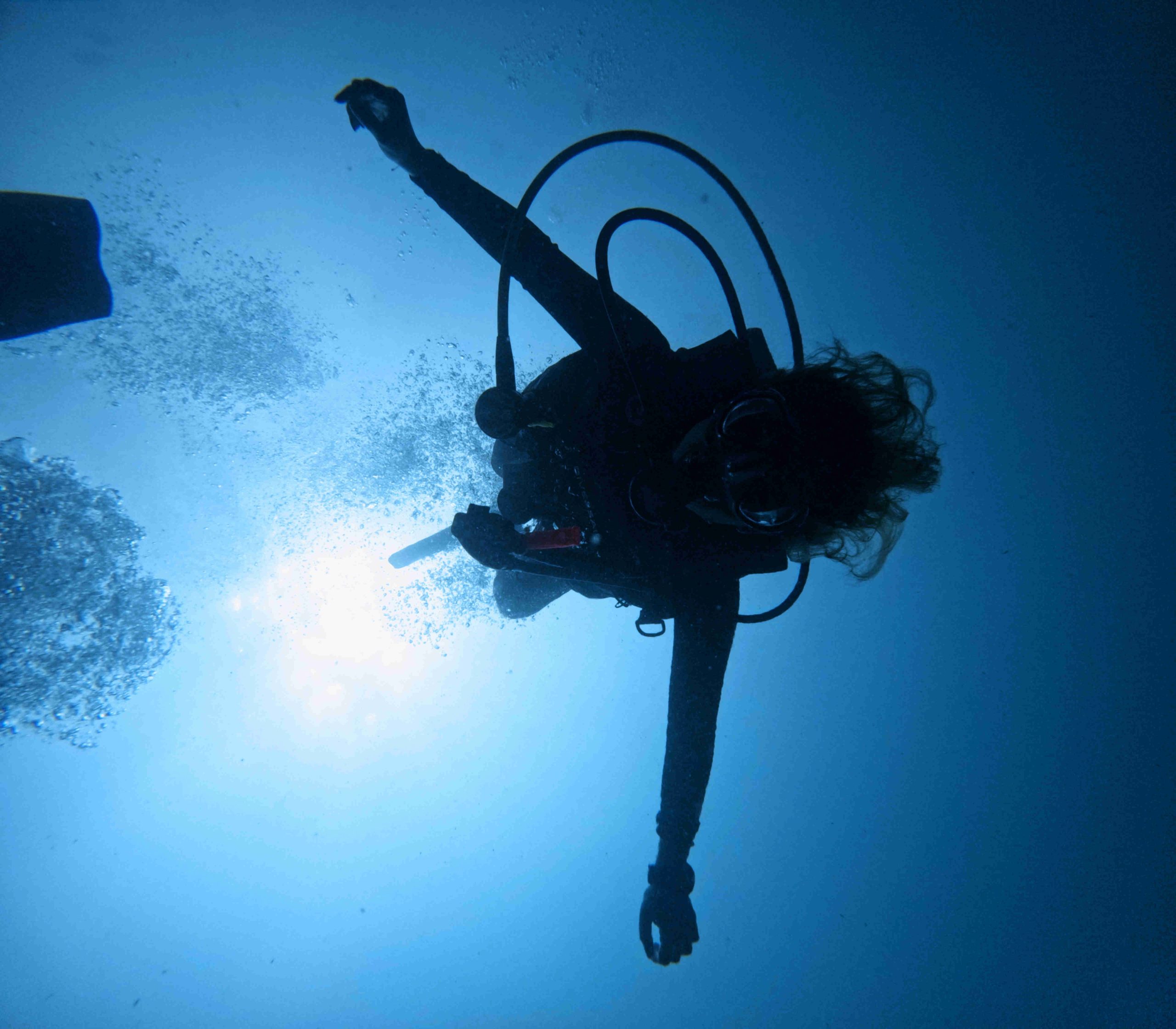 Diver submersing into the Pacific Ocean off of the coast of Guanacaste, Costa Rica