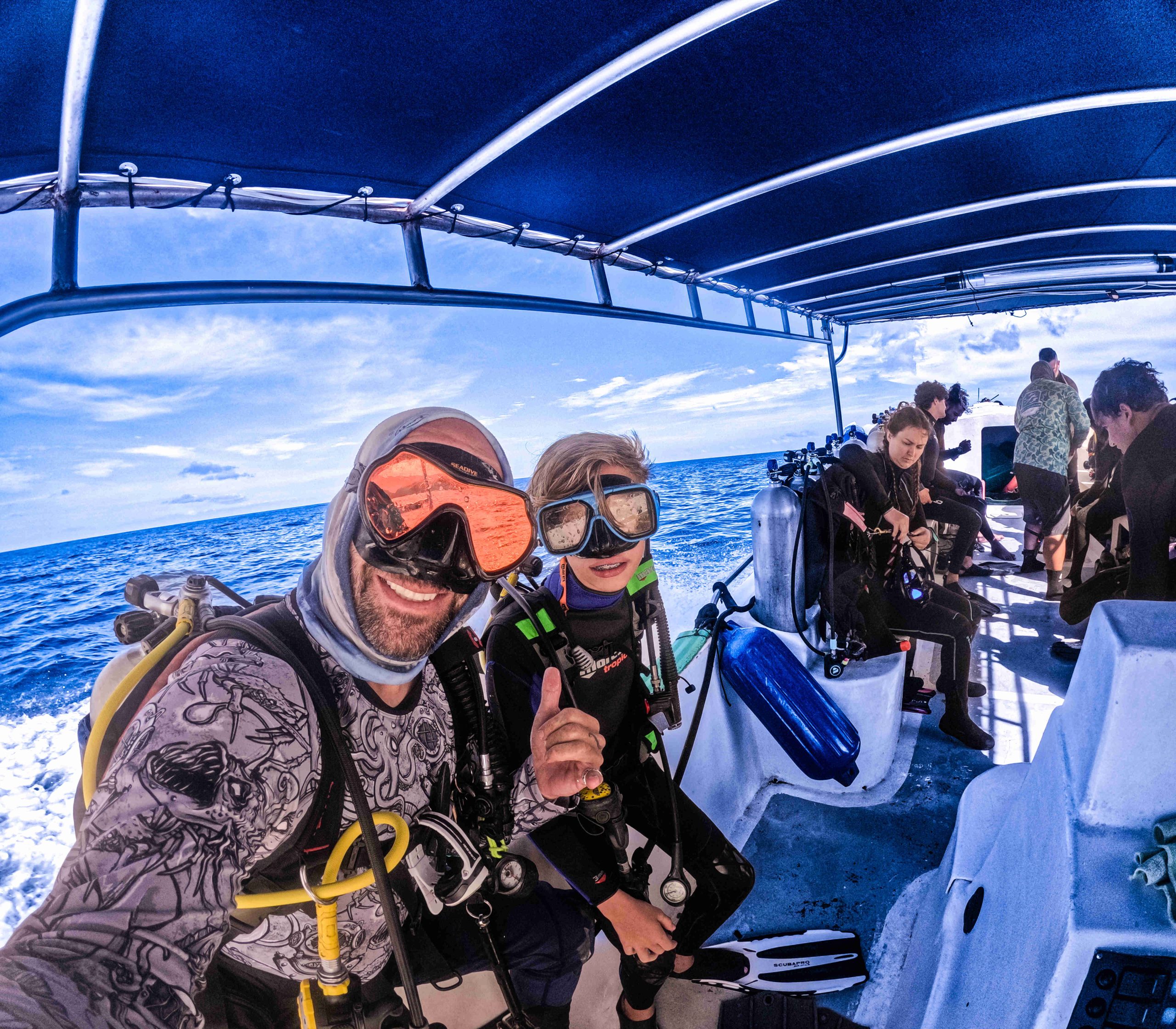 Divers on a boat getting ready to get under the waves off of the coast of Playa Flamingo Guanacaste
