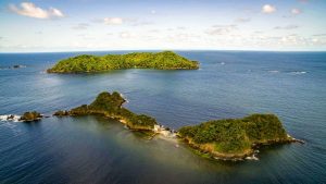 A drone view of Bat Islands in Guanacaste Costa Rica, lush green islands surrounded by the blue waters of the Pacific Ocean