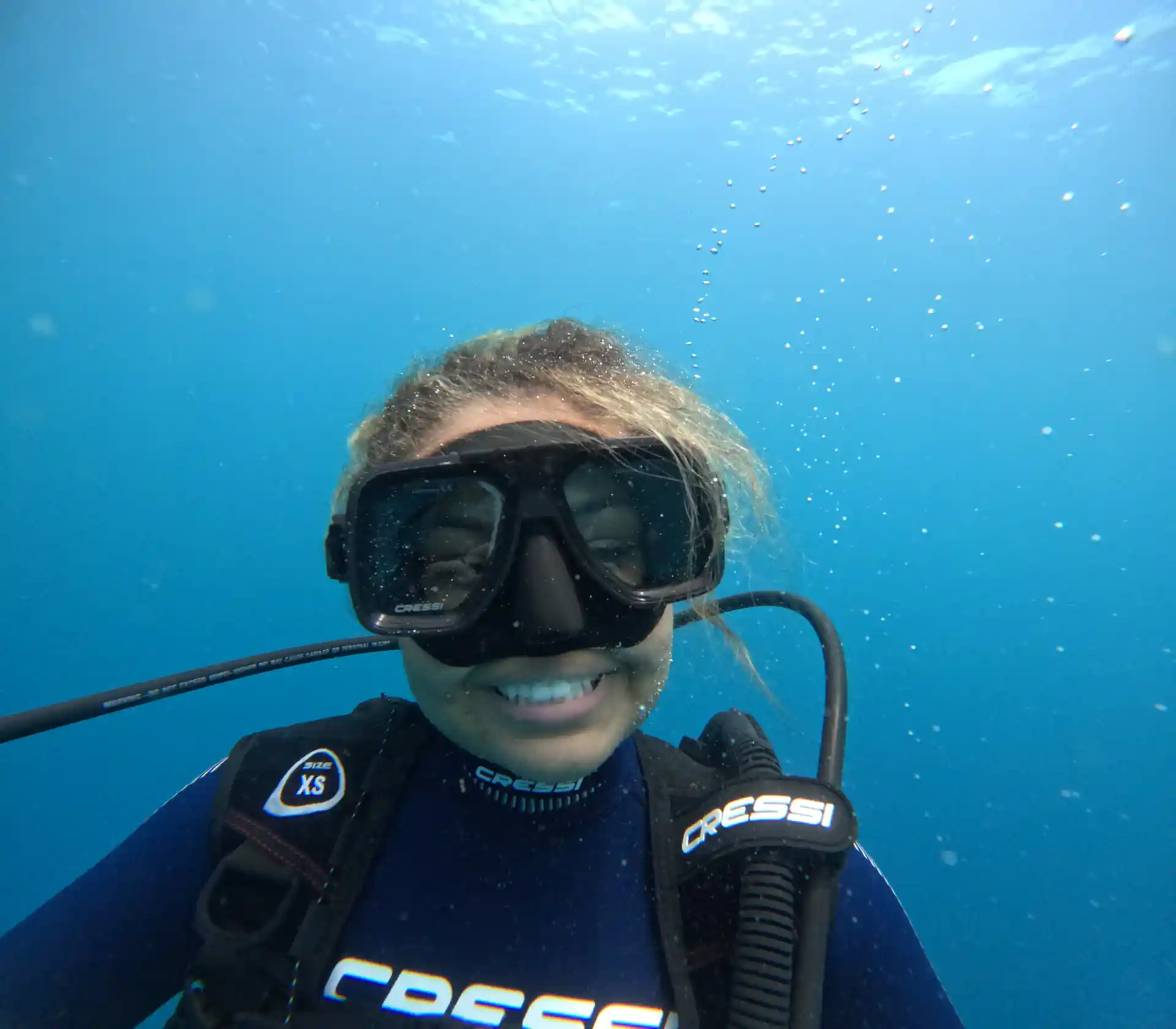 Happy diver smiling while diving for the first time after PADI certification course with Under The Sea Diving