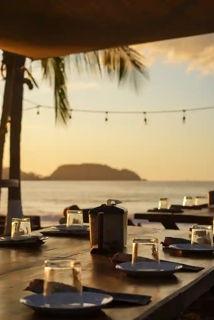 Tables on Playa Potrero at sunset for dinner at Hemmingways Playa Potrero Costa Rica